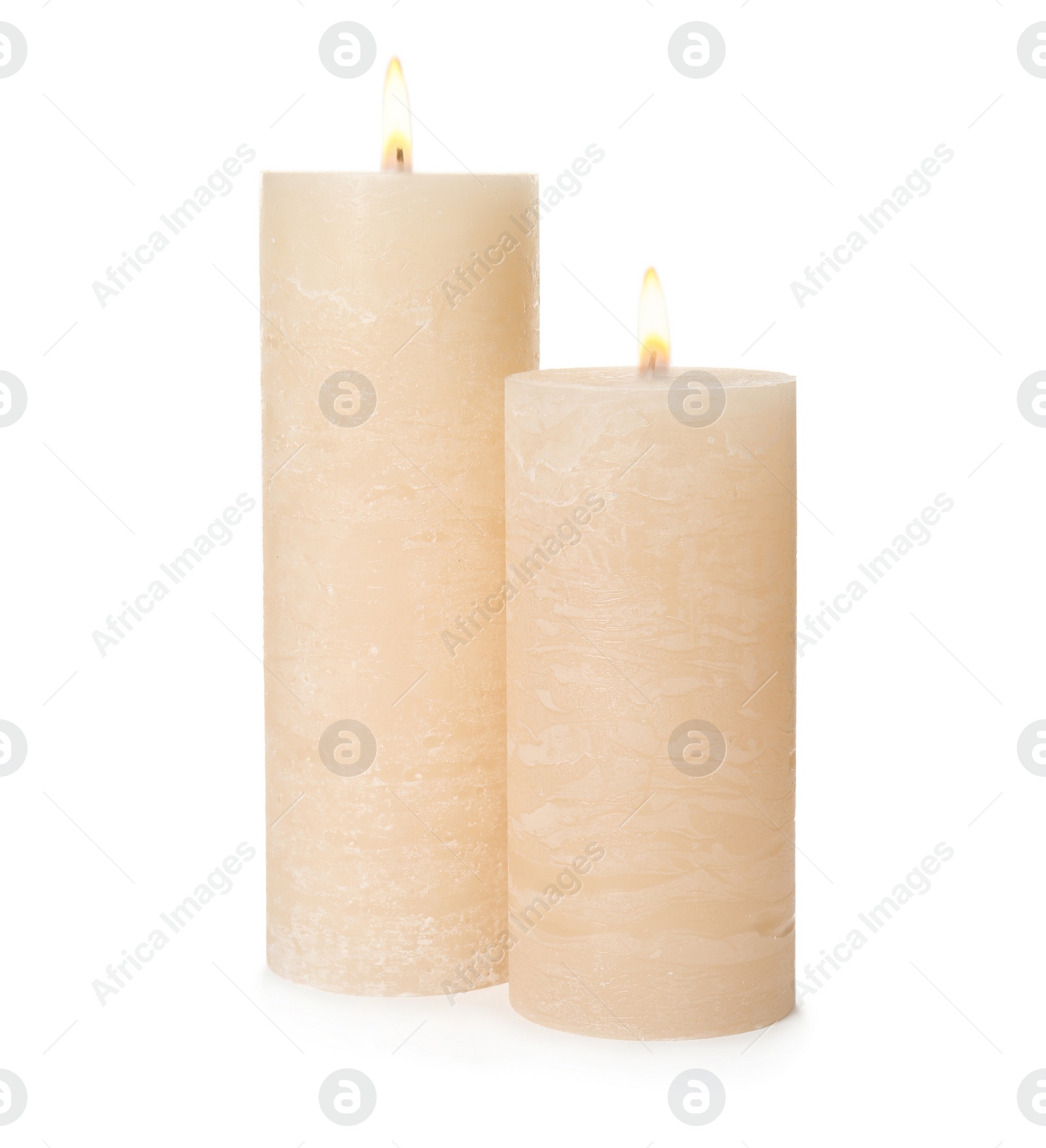 Photo of Two alight wax candles on white background