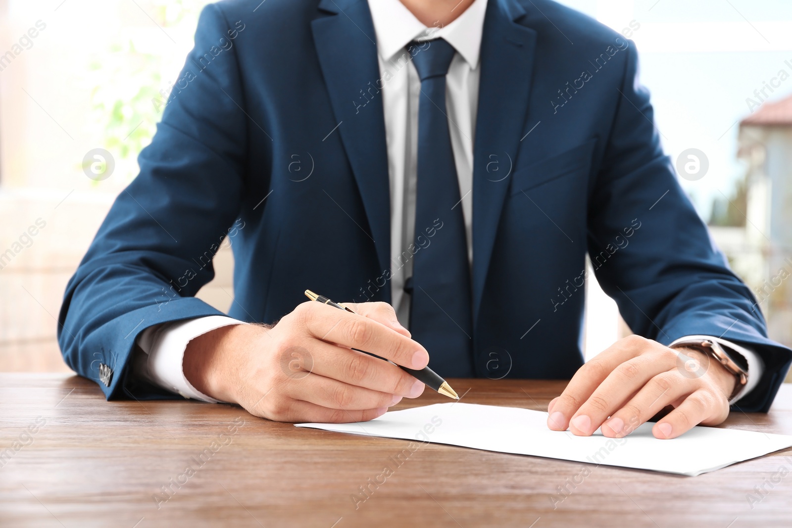 Photo of Lawyer working with documents at table, focus on hands