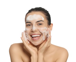 Happy young woman washing face with cosmetic product on white background