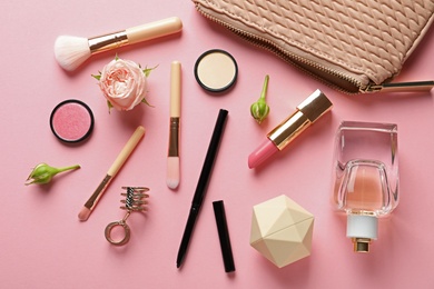 Photo of Flat lay composition with products for decorative makeup on pastel pink background