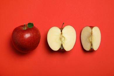 Photo of Flat lay composition with ripe juicy apples on red background