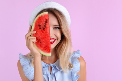 Pretty young woman with juicy watermelon on color background