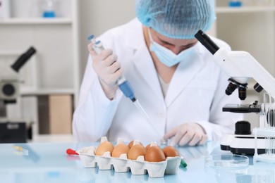Photo of Quality control. Food inspector working in laboratory, focus on eggs