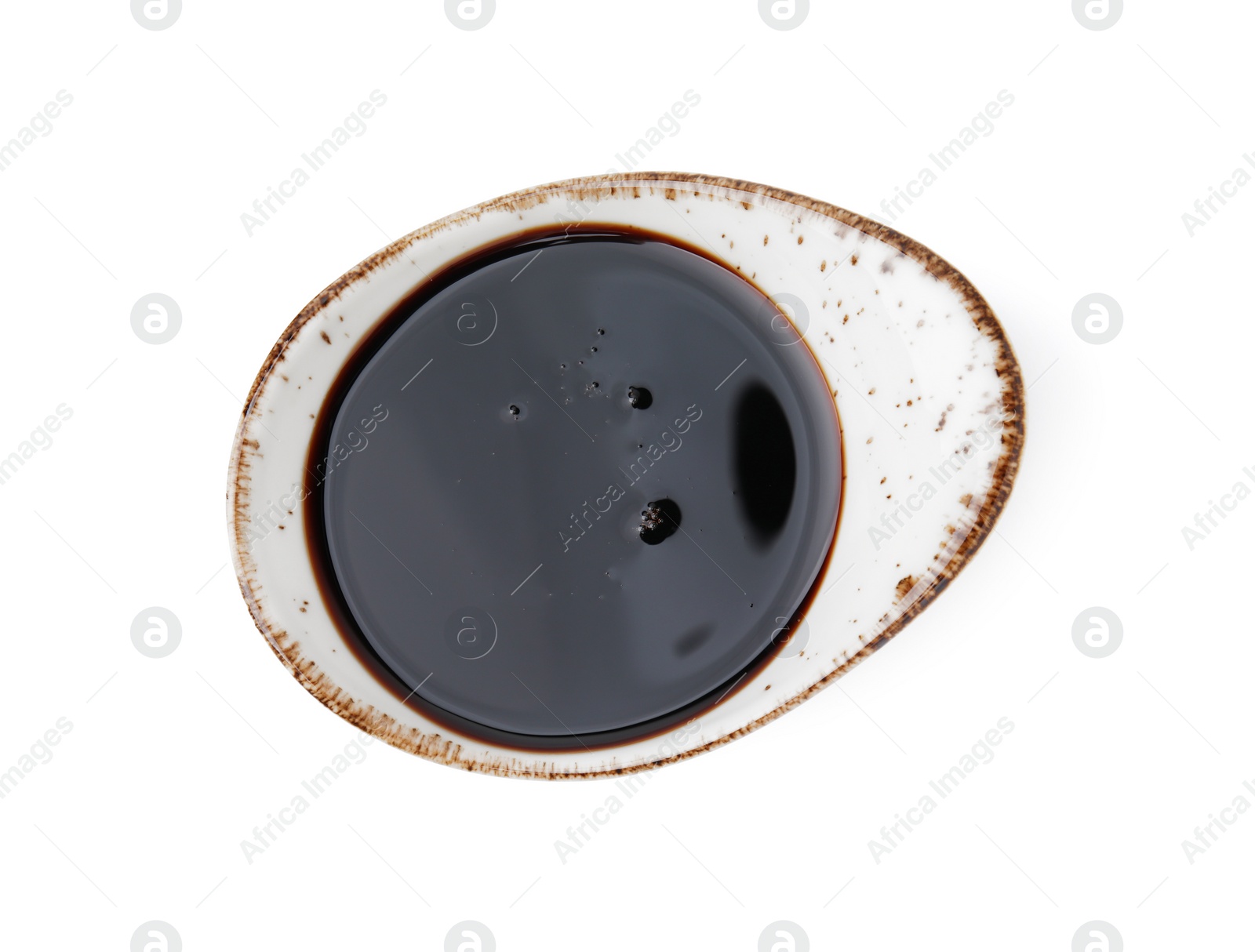 Photo of Tasty pomegranate sauce in gravy boat isolated on white, top view