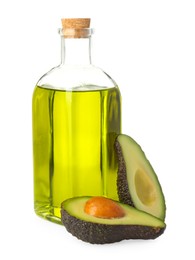 Photo of Vegetable fats. Bottle of cooking oil and fresh cut avocado isolated on white