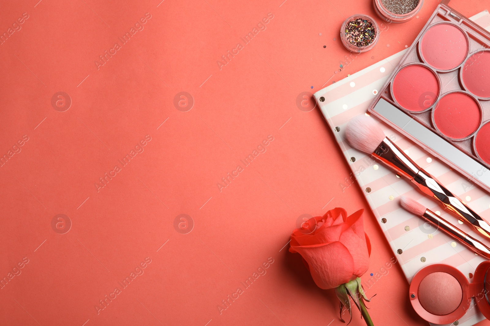 Photo of Flat lay composition with beauty accessories and space for text on coral background