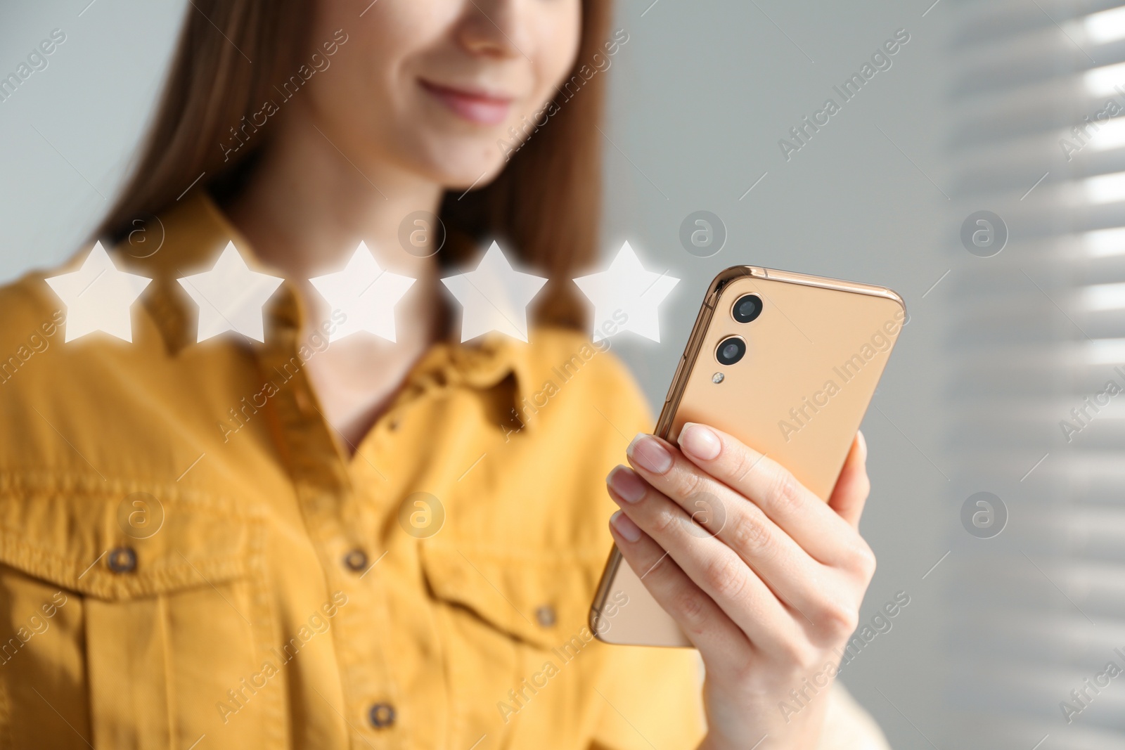 Image of Woman with smartphone giving feedback indoors, closeup. Customer review