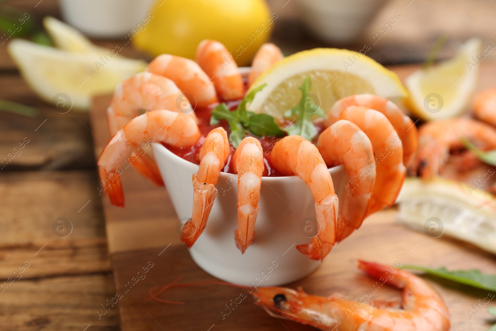 Photo of Delicious shrimp cocktail served on board, closeup