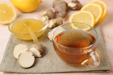 Photo of Tea, honey, lemon and ginger on table