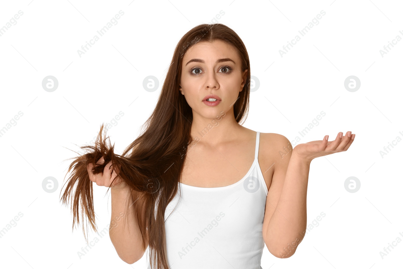 Photo of Emotional woman with damaged hair on white background. Split ends