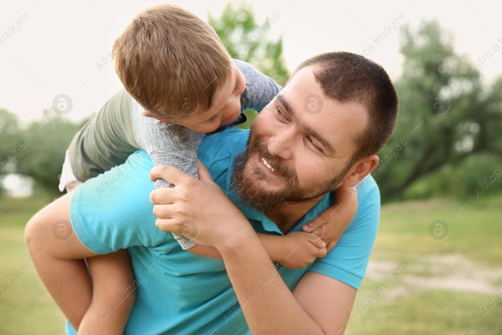 Photo of Man with his child outdoors. Happy family