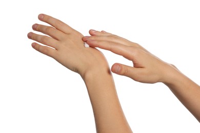 Woman applying cream on her hand against white background, closeup