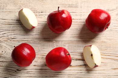 Ripe red apples on wooden background, flat lay