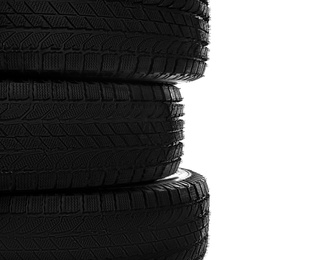 Photo of Set of new winter tires on white background, closeup