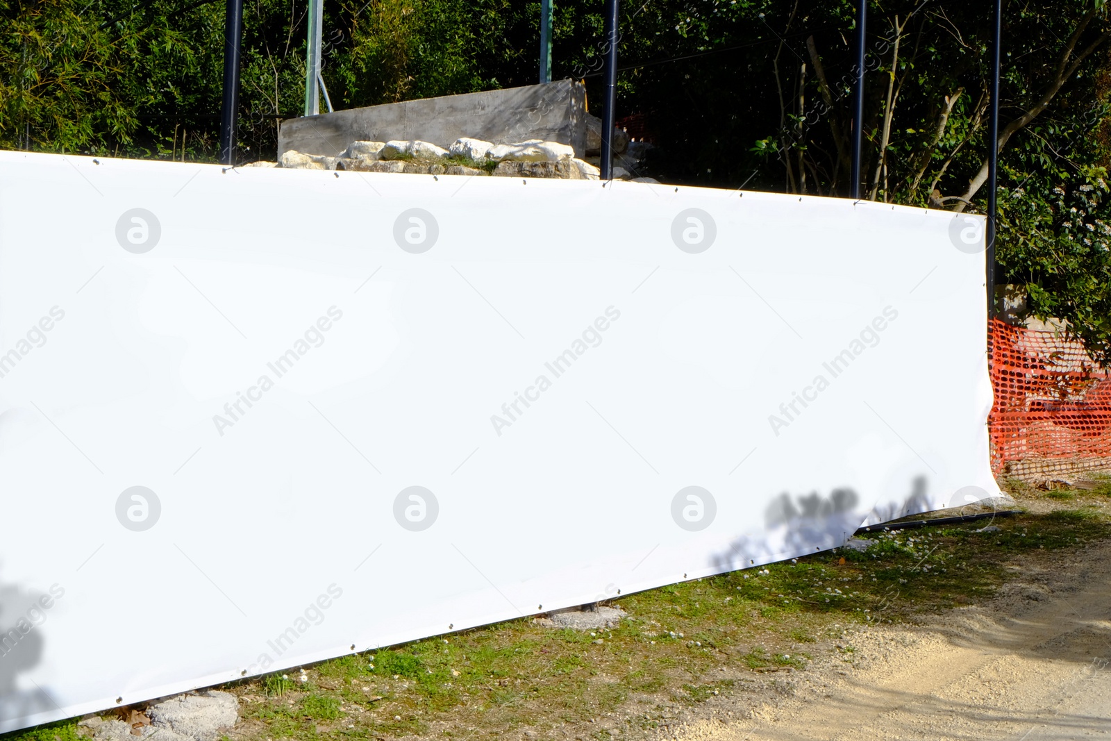 Photo of Big blank banner near trees outdoors on sunny day