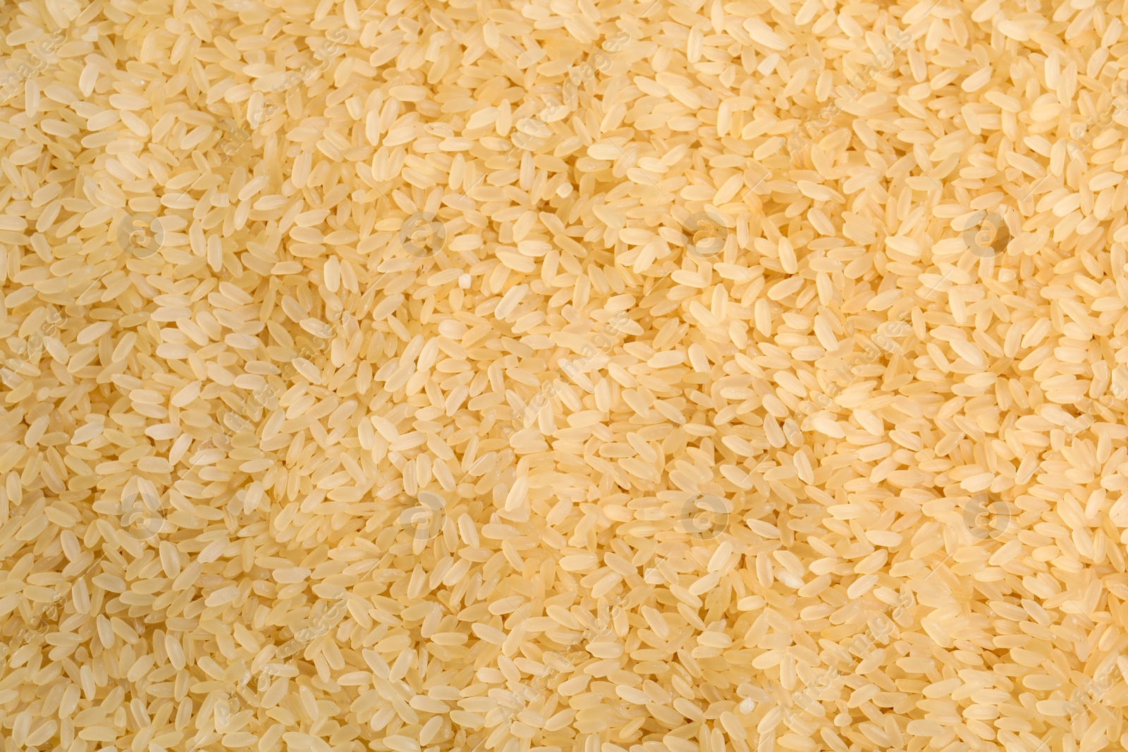 Photo of Heap of rice as background, top view. Veggie seeds