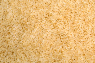 Photo of Heap of rice as background, top view. Veggie seeds