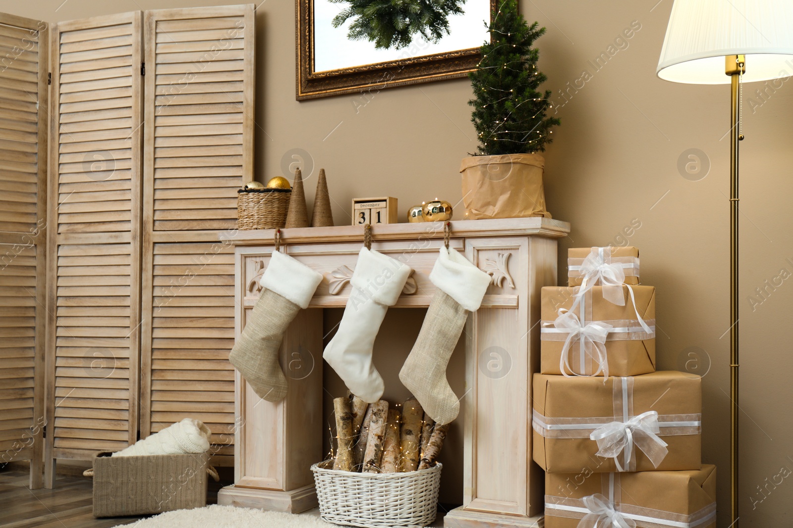 Photo of Fireplace with Christmas stockings in festive room interior