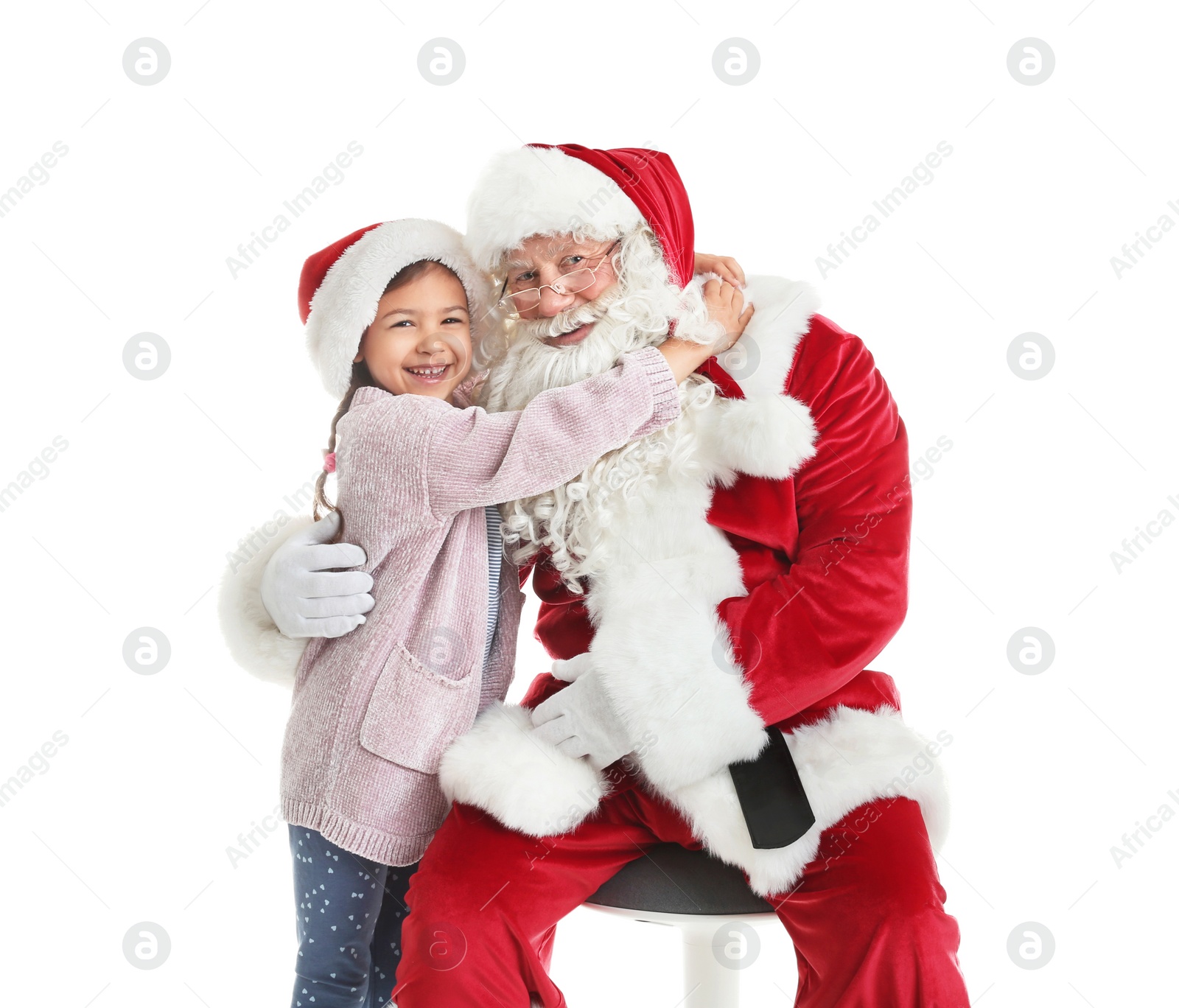 Photo of Little girl hugging authentic Santa Claus on white background