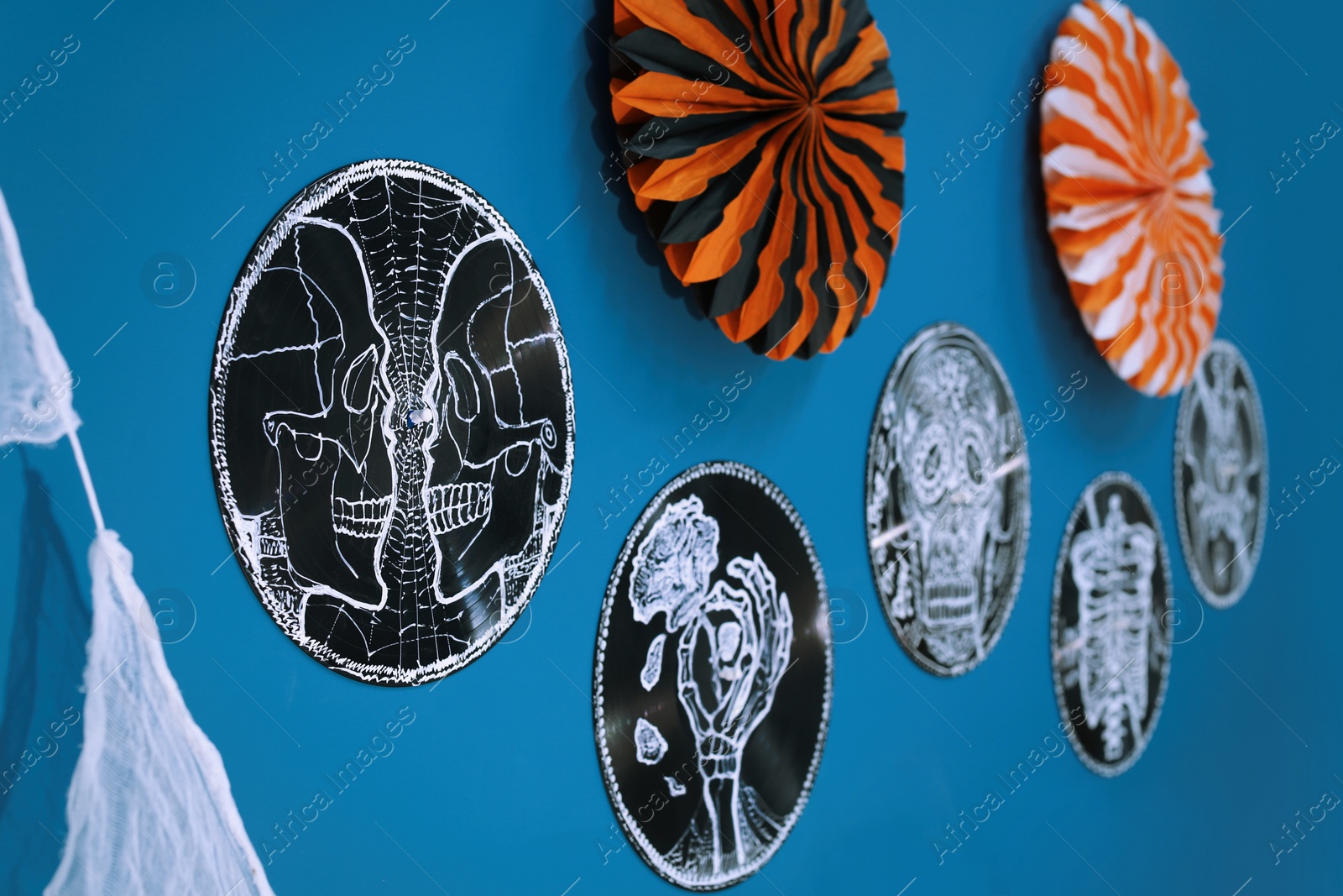 Photo of Different beautiful Halloween decorations on blue wall