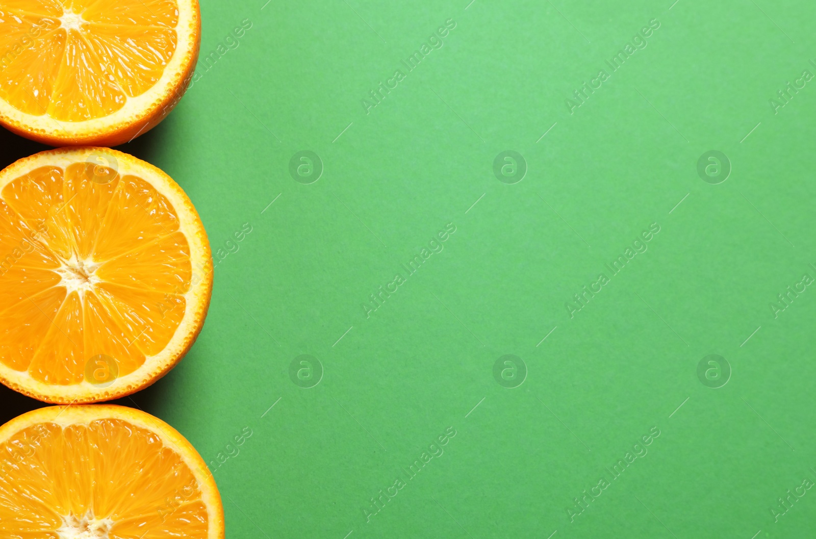 Photo of Flat lay composition with ripe oranges and space for text on color background