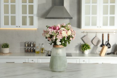 Photo of Beautiful bouquet of fresh flowers in vase on table indoors