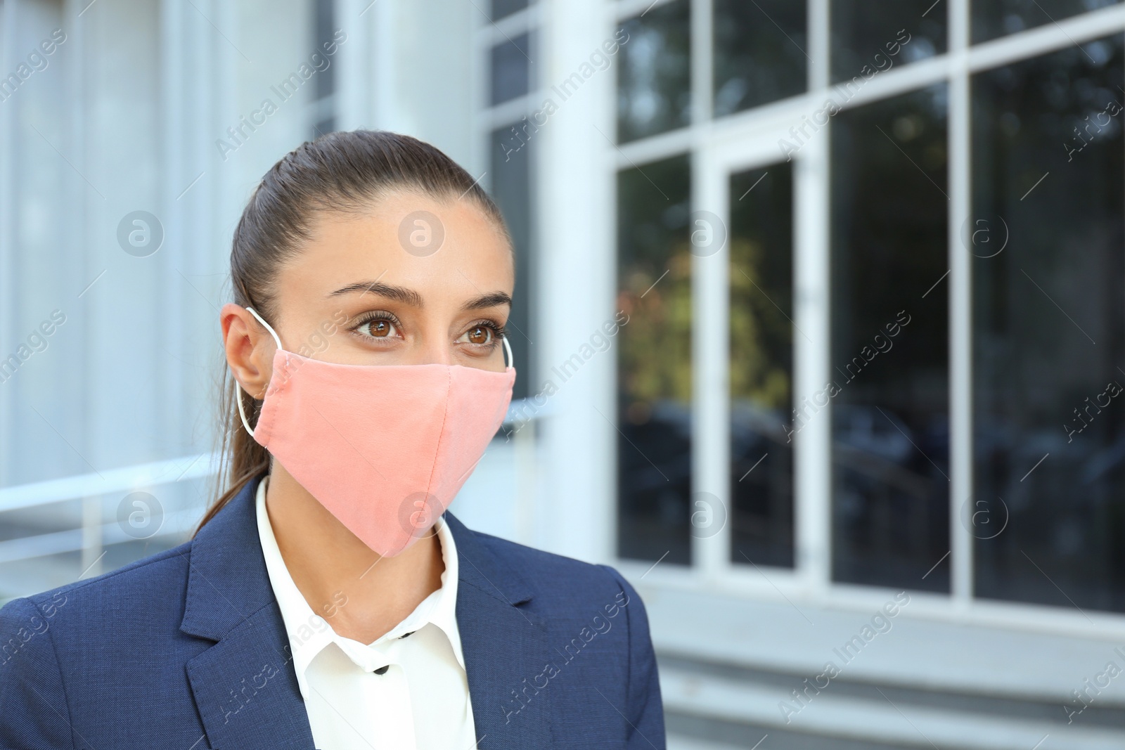 Photo of Woman wearing handmade cloth mask outdoors, space for text. Personal protective equipment during COVID-19 pandemic