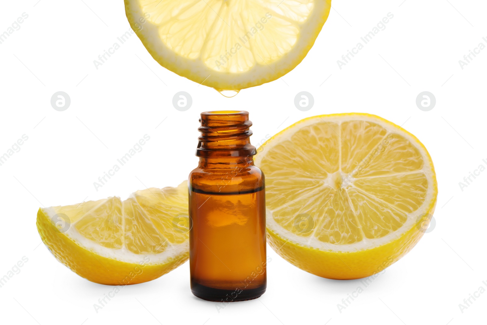 Photo of Dripping lemon essential oil from into bottle isolated on white