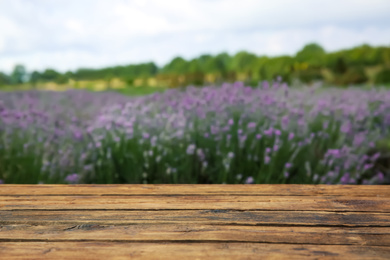 Photo of Empty wooden table in fresh lavender field