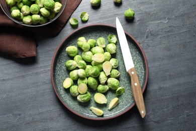 Photo of Plate with fresh Brussels sprouts on table, top view