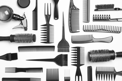 Photo of Composition with hair combs and brushes on white background, top view