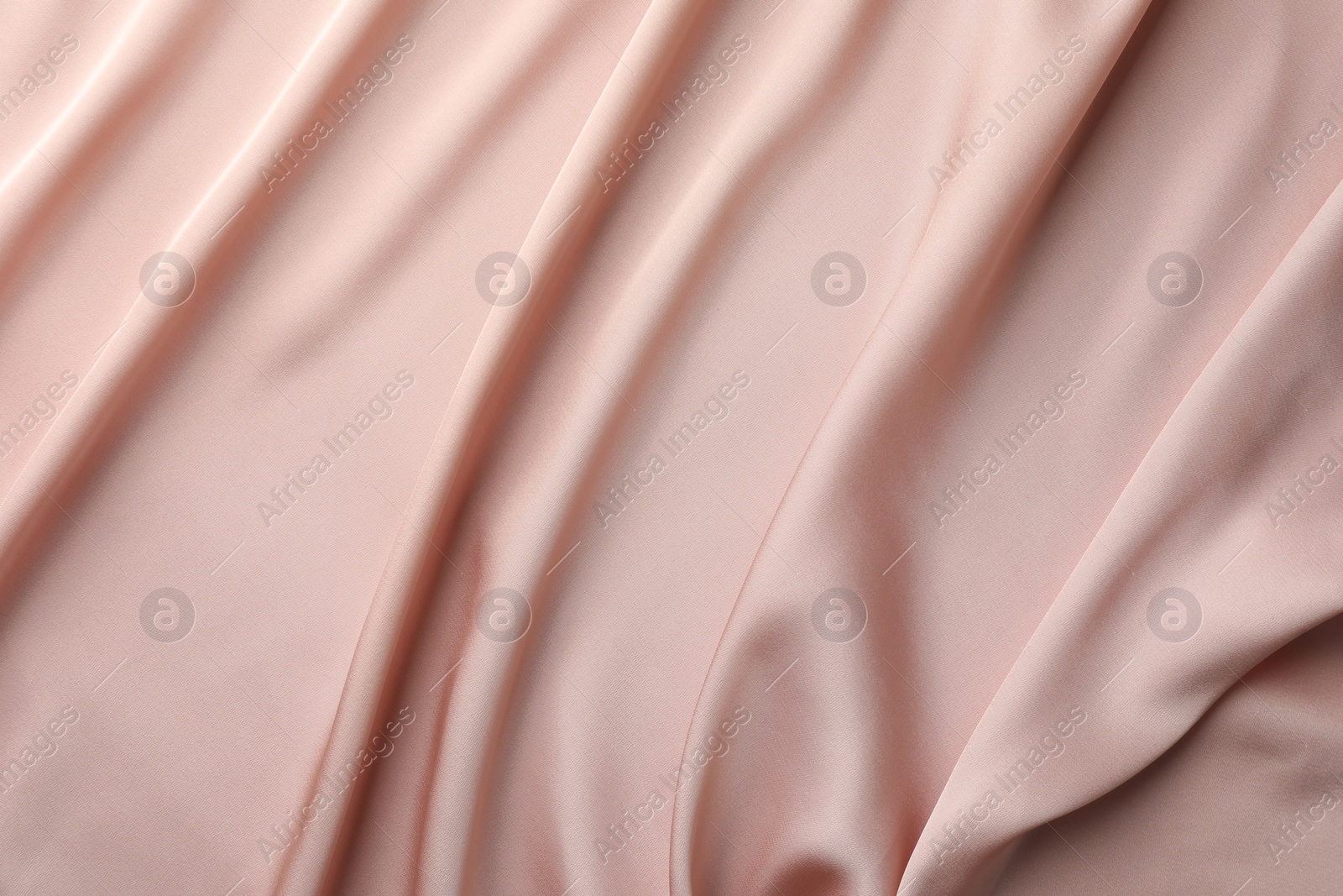 Photo of Crumpled pink silk fabric as background, top view