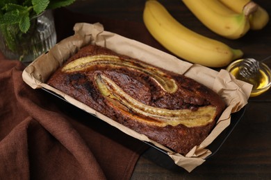 Photo of Delicious banana bread on wooden table, closeup