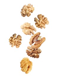 Image of Halves of walnuts falling on white background 