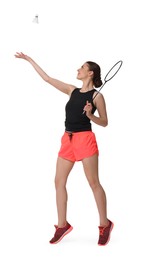 Young woman playing badminton with racket and shuttlecock on white background