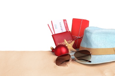 Photo of Composition with passport, tickets and beach objects on sand, space for text. Christmas vacation