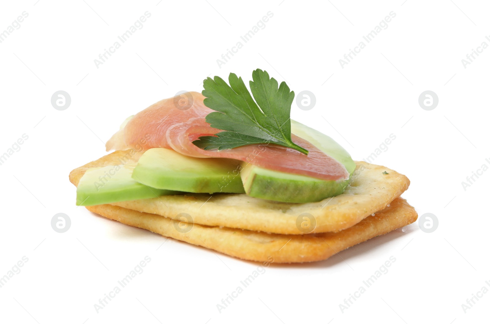 Photo of Delicious crackers with avocado, prosciutto and parsley on white background