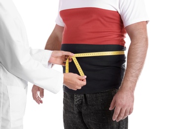 Photo of Doctor measuring fat man's waist on white background. Weight loss