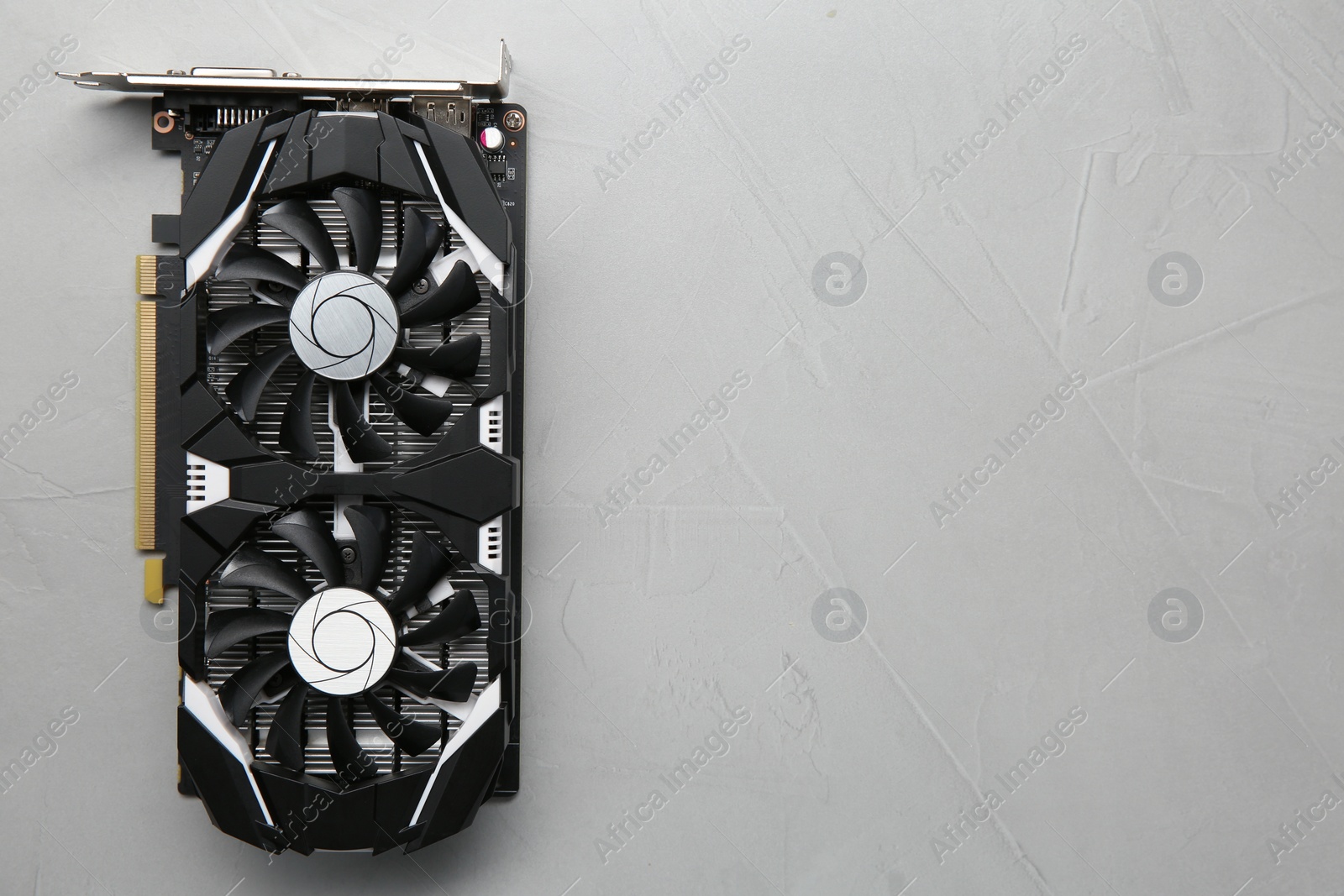 Photo of Computer graphics card on gray textured background, top view. Space for text