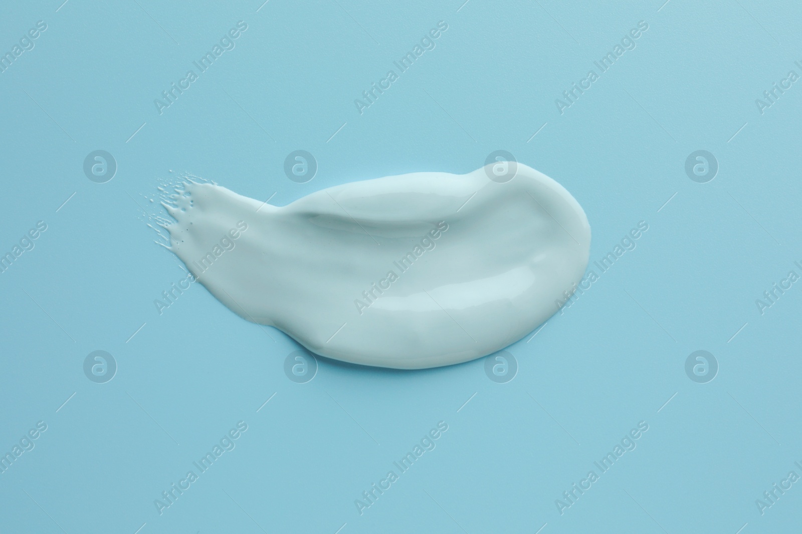 Photo of Sample of face mask on light blue background, top view