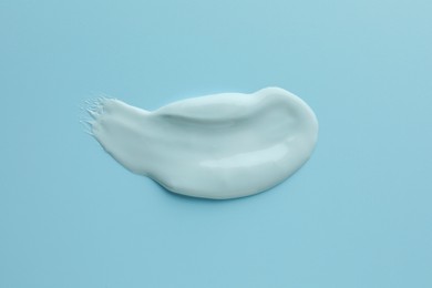 Photo of Sample of face mask on light blue background, top view