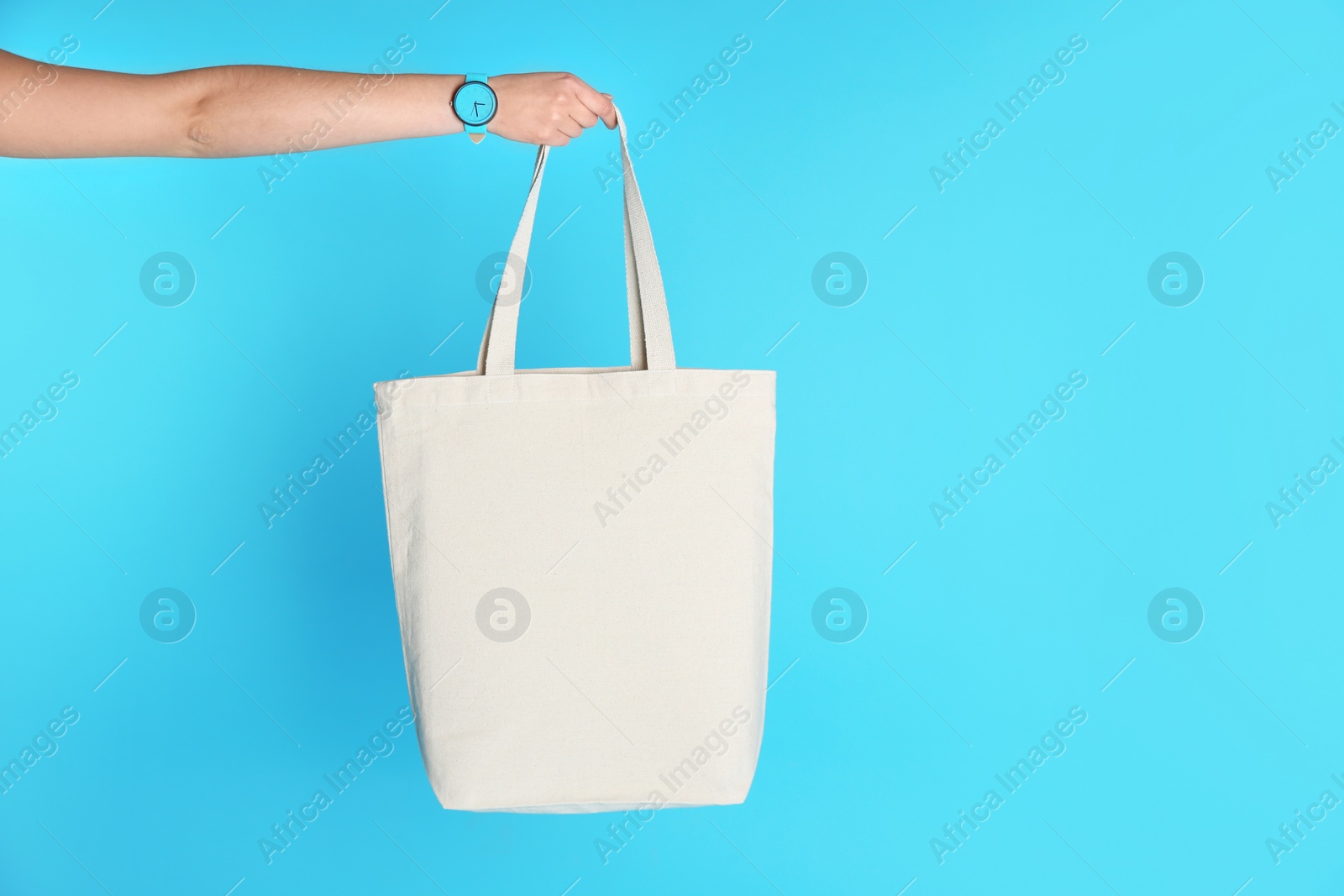 Photo of Woman holding eco bag on color background. Mock up for design