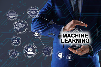 Man demonstrating machine learning model with linked icons on dark background, closeup