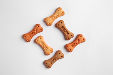 Photo of Bone shaped dog cookies on white background, top view