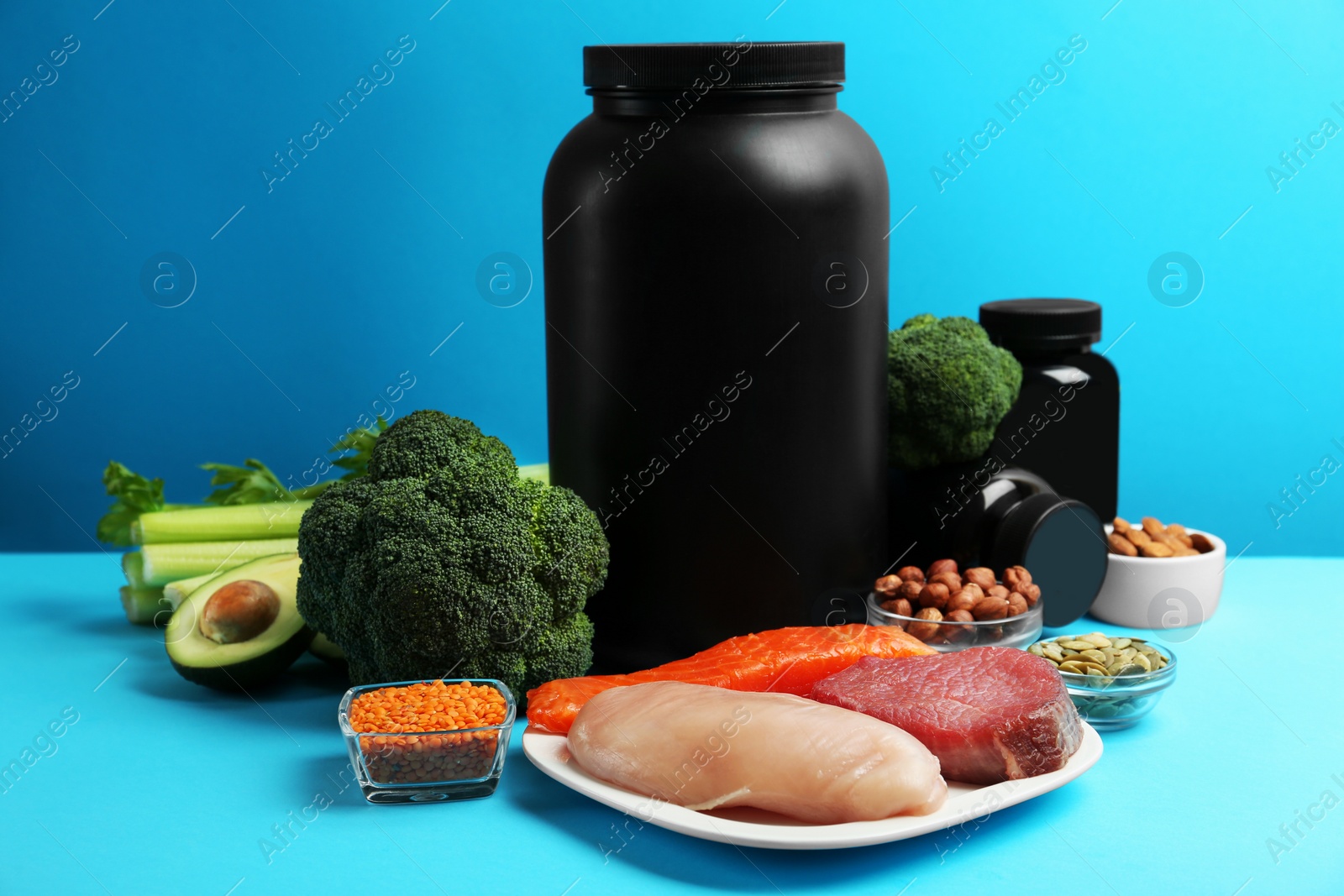 Photo of Set of products rich in amino acids and supplements on light blue background