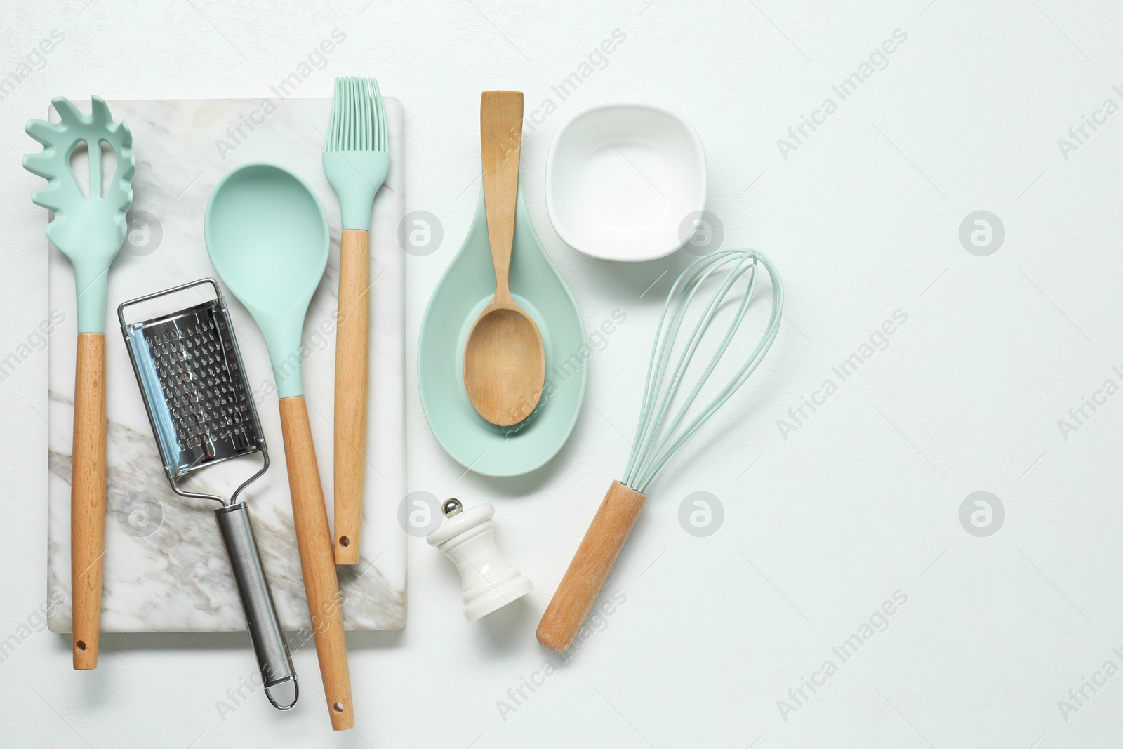 Photo of Set of different kitchen utensils on white table, flat lay. Space for text