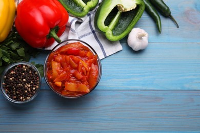 Photo of Delicious lecho and ingredients on light blue wooden table, flat lay. Space for text