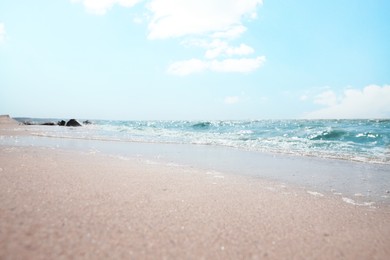 Photo of Tropical sandy beach washed by sea on sunny day