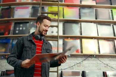 Image of Young man with vinyl records in store