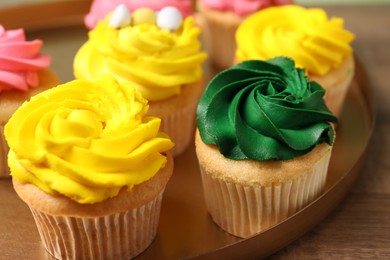 Photo of Delicious cupcakes with bright cream on table, closeup